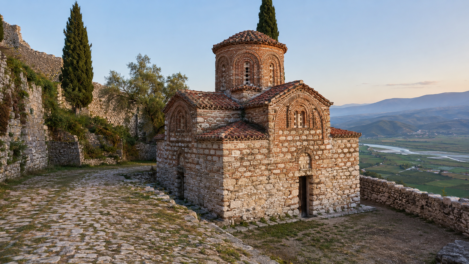 Historic stone church with red tiled roof inside Berat Castle