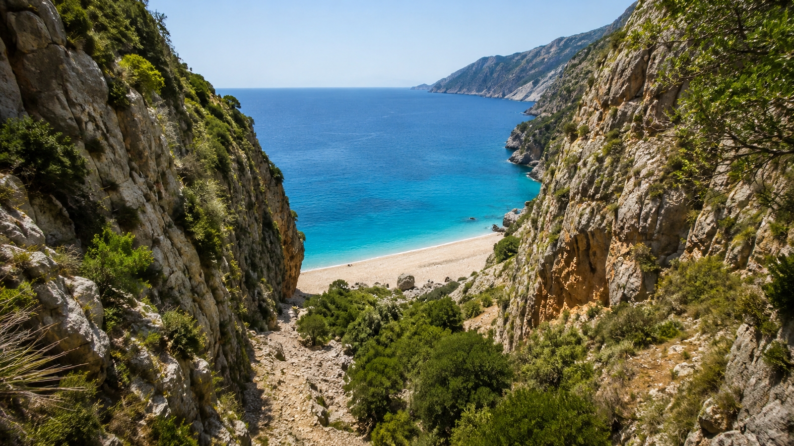 Clear blue water and bright shoreline at Dhërmi Beach