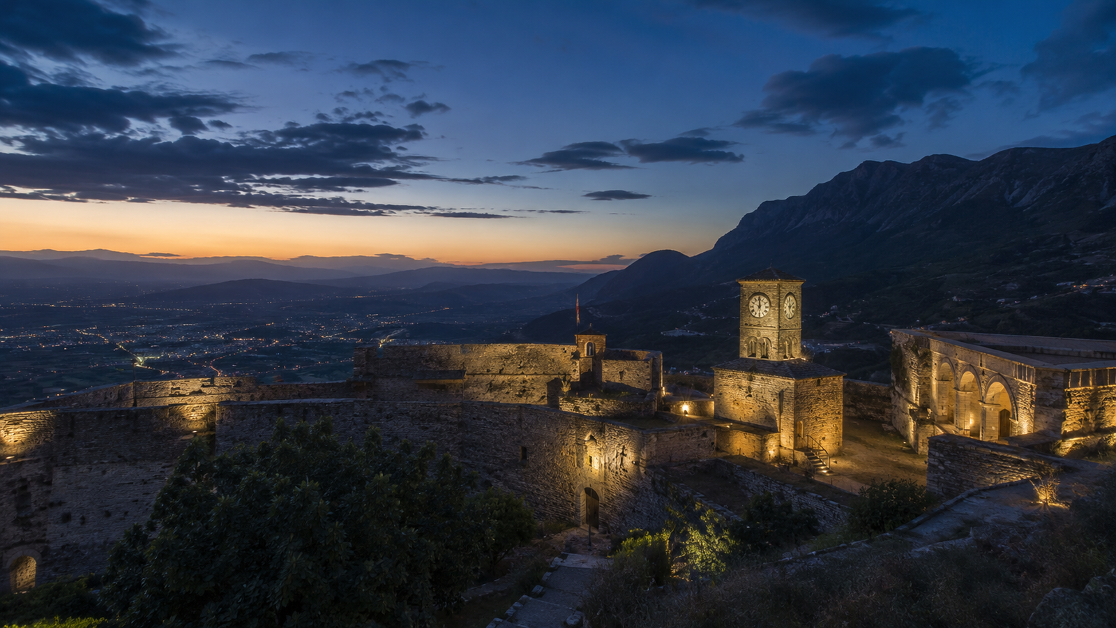 Krujë Castle and mountain slope illuminated at sunset