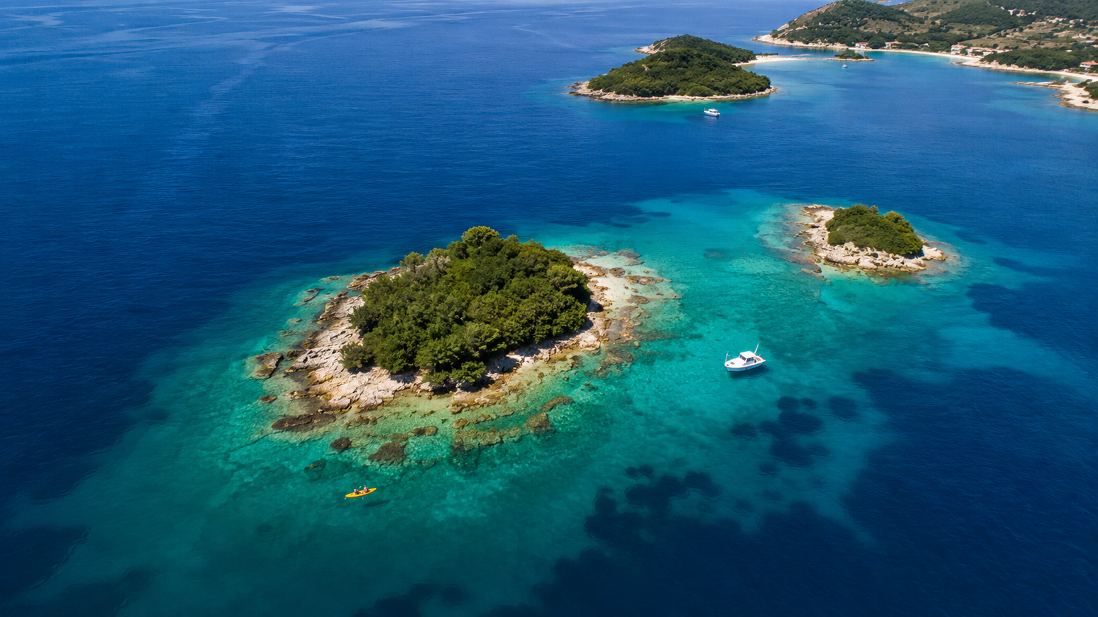 Aerial view of the small green Ksamil Islands in clear Ionian water