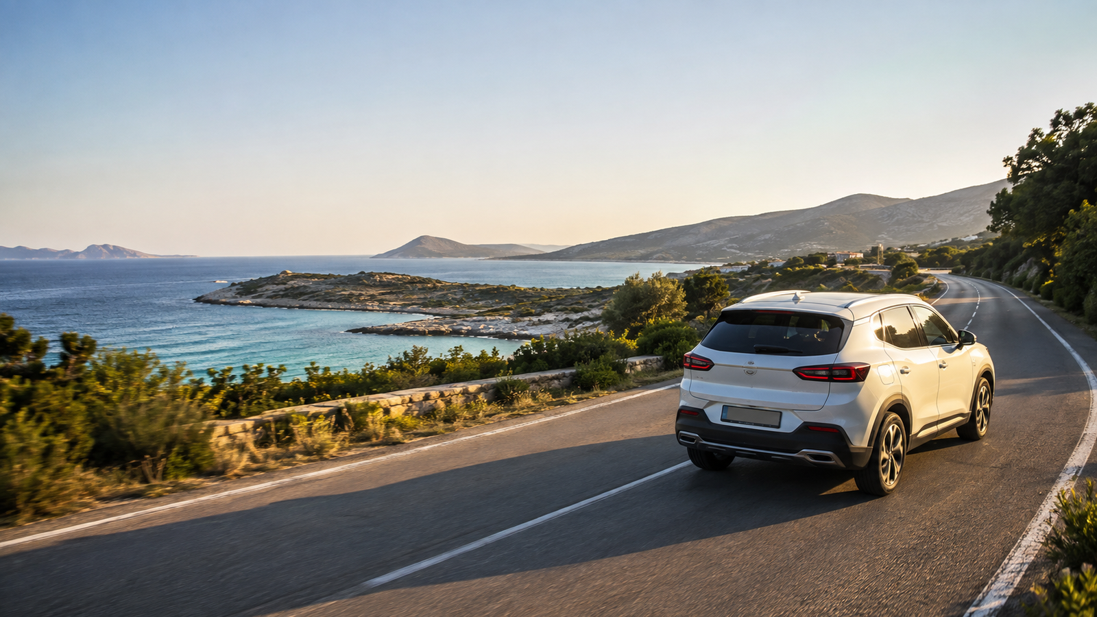 Rental crossover driving on a scenic coastal road near Ksamil